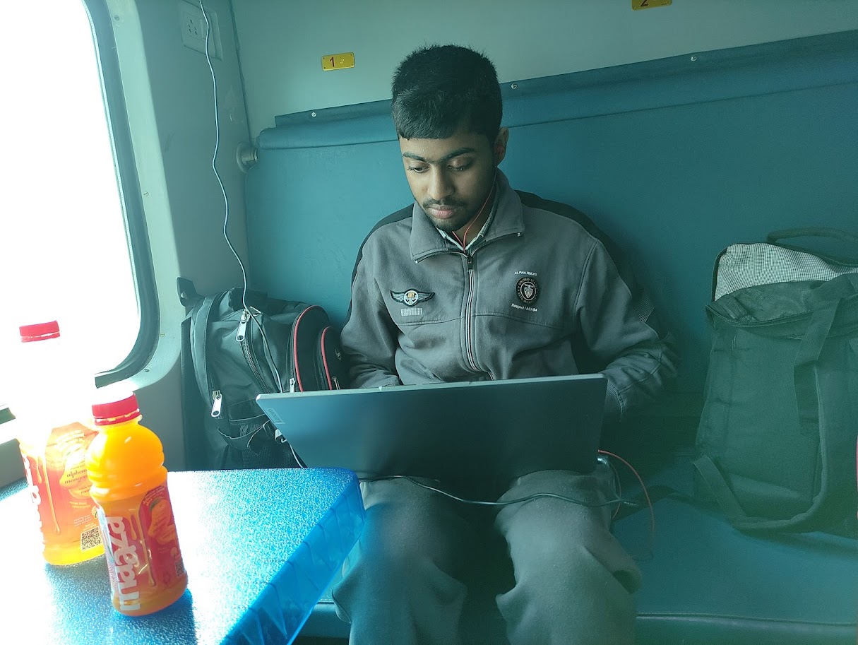 Navneet working on Laptop in train